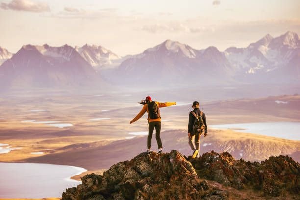 Travellers celebrating on a mountain summit